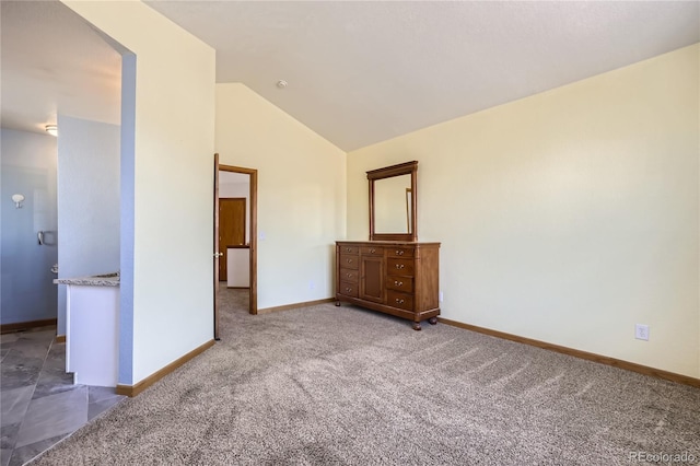 unfurnished bedroom featuring high vaulted ceiling and carpet floors