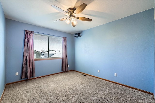 unfurnished room with ceiling fan and carpet flooring