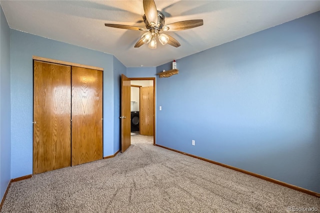 unfurnished bedroom featuring ceiling fan, a closet, washer / clothes dryer, and light colored carpet