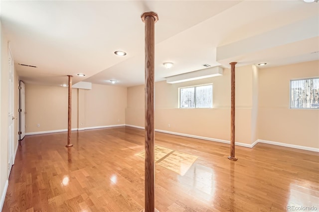 basement featuring hardwood / wood-style floors and a healthy amount of sunlight