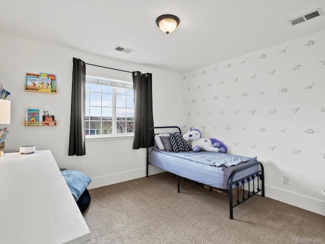 carpeted bedroom featuring baseboards and visible vents
