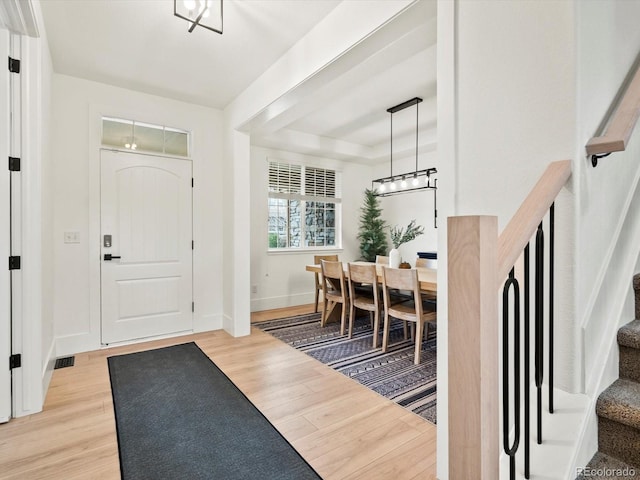 2463 Tavern Way, Castle Rock, CO 80104 - entrance foyer with light wood-style floors, stairway, baseboards, and a raised ceiling