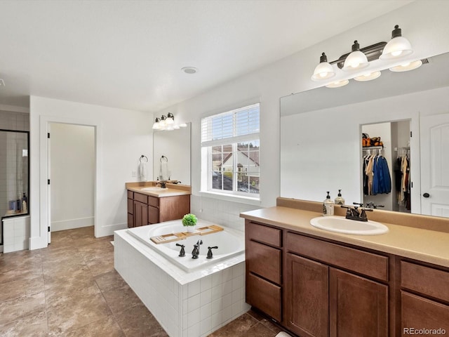 2463 Tavern Way, Castle Rock, CO 80104 - bathroom featuring a bath, two vanities, a stall shower, and a spacious closet