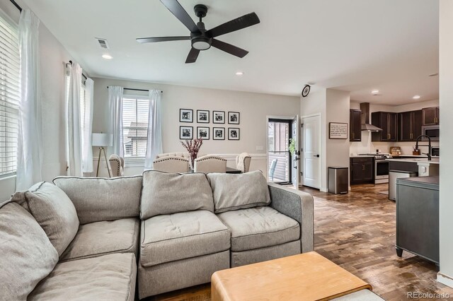 8433 Mount Kataka Loop, Littleton, CO 80125 - living room featuring plenty of natural light, a ceiling fan, visible vents, and wood finished floors