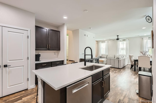 8433 Mount Kataka Loop, Littleton, CO 80125 - kitchen with stainless steel dishwasher, ceiling fan, a sink, wood finished floors, and light countertops