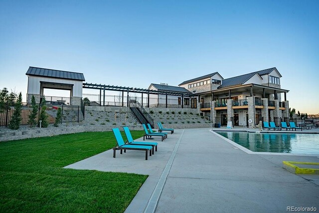 8433 Mount Kataka Loop, Littleton, CO 80125 - community pool with fence, a patio area, and a lawn