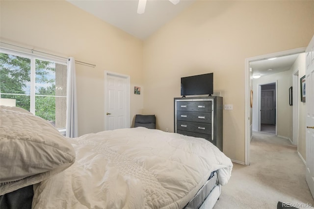 bedroom with high vaulted ceiling, light colored carpet, and ceiling fan