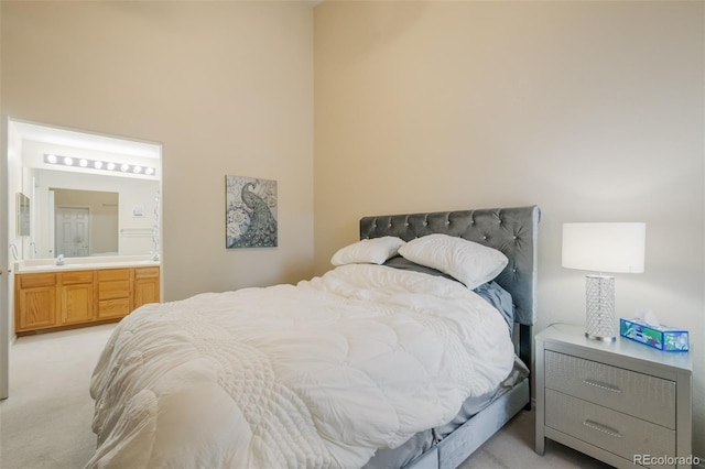 carpeted bedroom featuring ensuite bathroom