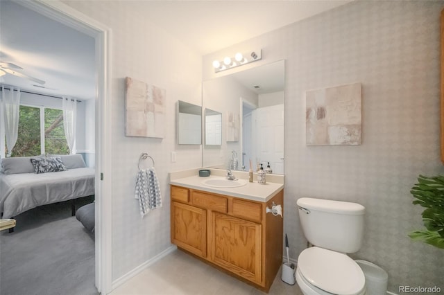 bathroom with ceiling fan, vanity, and toilet