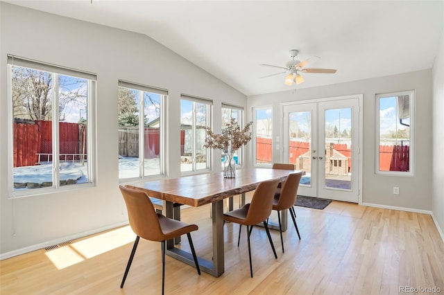 sunroom with lofted ceiling, ceiling fan, and french doors