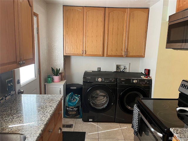 2285 S Jasper Way Unit A, Aurora, CO 80013 - laundry room with independent washer and dryer and light tile patterned floors