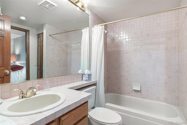 9873 Greensview Cir, Lone Tree, CO 80124 - bathroom featuring vanity, shower / bathtub combination with curtain, connected bathroom, and a textured ceiling