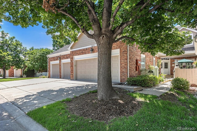 9873 Greensview Cir, Lone Tree, CO 80124 - view of front of house featuring driveway, brick siding, and an attached garage