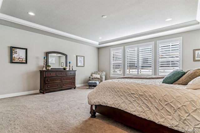 bedroom featuring ornamental molding, a raised ceiling, carpet, and a textured ceiling