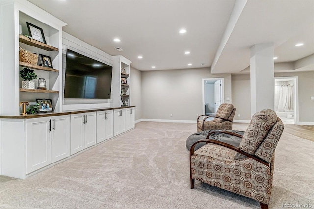 living area with light colored carpet