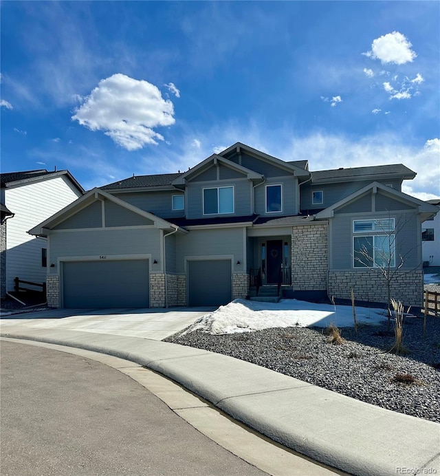 view of front of house with stone siding and driveway