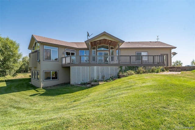 rear view of house with a lawn and a deck