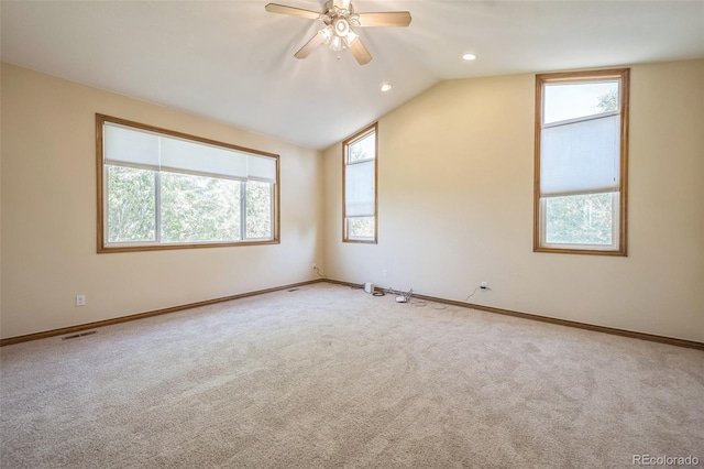 carpeted empty room with lofted ceiling and ceiling fan