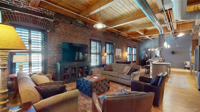 1745 Wazee St Unit 4H, Denver, CO 80202 - living area featuring a wood ceiling with exposed beams, wood finished floors, plenty of natural light, and brick wall