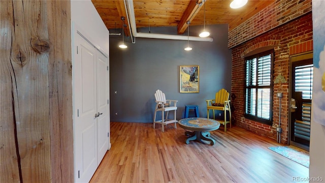 1745 Wazee St Unit 4H, Denver, CO 80202 - living area with brick wall, wood finished floors, and a wooden ceiling with exposed beams