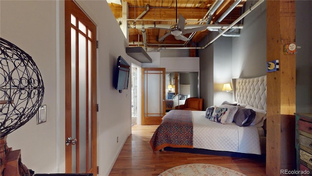 1745 Wazee St Unit 4H, Denver, CO 80202 - bedroom featuring wood finished floors and a towering ceiling