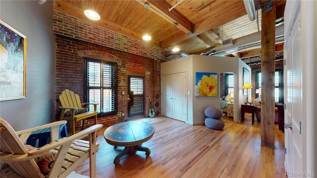 1745 Wazee St Unit 4H, Denver, CO 80202 - living area featuring brick wall, a wooden ceiling with exposed beams, and wood finished floors