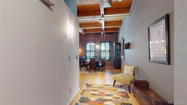 1745 Wazee St Unit 4H, Denver, CO 80202 - hall with wood finished floors, brick wall, and beamed ceiling