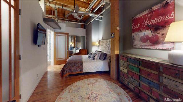 1745 Wazee St Unit 4H, Denver, CO 80202 - bedroom featuring wood finished floors and a high ceiling