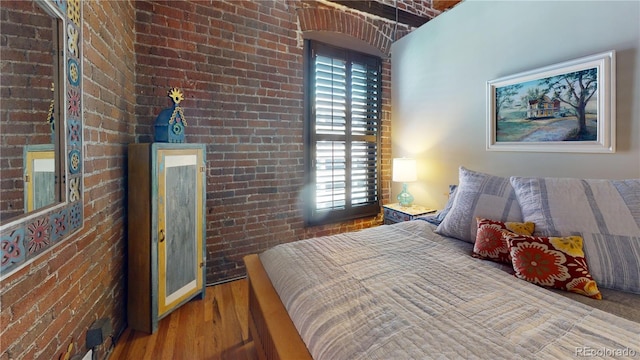 1745 Wazee St Unit 4H, Denver, CO 80202 - bedroom featuring brick wall, wood finished floors, and multiple windows