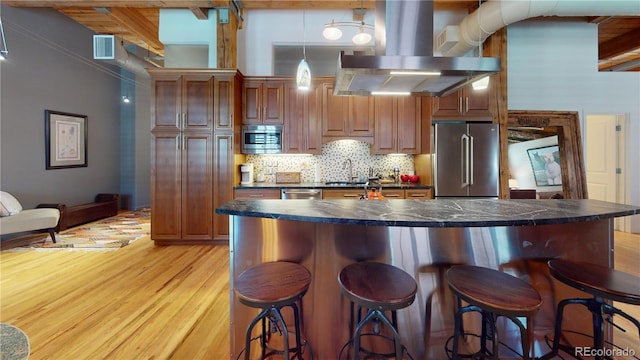 1745 Wazee St Unit 4H, Denver, CO 80202 - kitchen featuring appliances with stainless steel finishes, exhaust hood, dark countertops, light wood finished floors, and beam ceiling