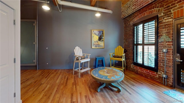 1745 Wazee St Unit 4H, Denver, CO 80202 - sitting room featuring brick wall and wood finished floors