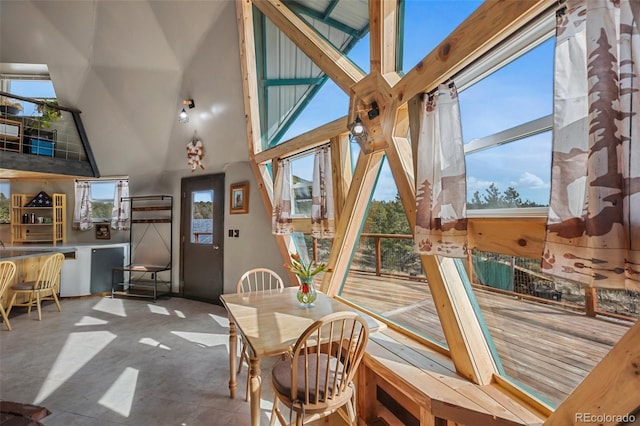 dining area with concrete flooring and a high ceiling