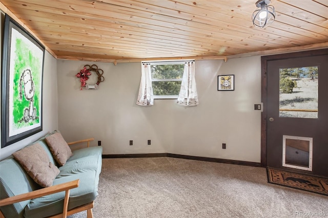 living area with carpet floors, wood ceiling, and baseboards