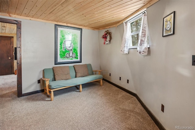 sitting room with carpet, wood ceiling, and baseboards