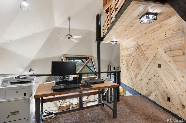 carpeted office space featuring wooden walls, ceiling fan, and a high ceiling