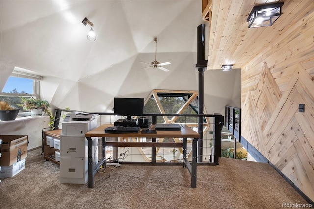 carpeted home office with a high ceiling and wooden walls