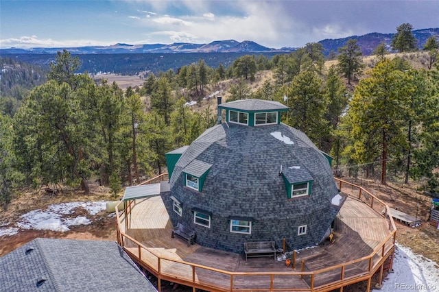 drone / aerial view with a mountain view and a forest view