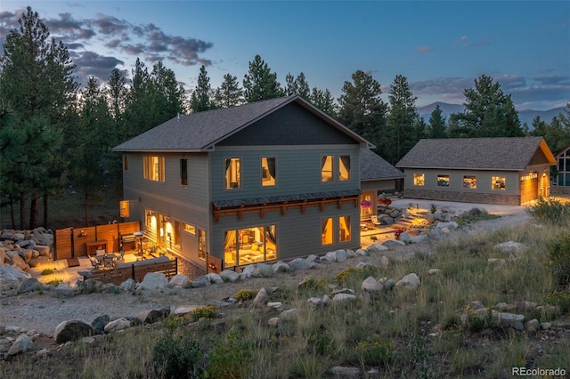 back house at dusk featuring a mountain view