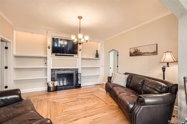 living room with built in features, arched walkways, ornamental molding, and a fireplace