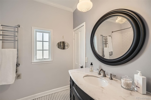 bathroom with baseboards, vanity, and crown molding