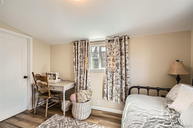 bedroom with baseboards and wood finished floors