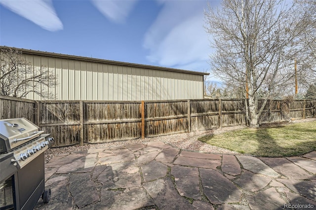 view of patio with grilling area and a fenced backyard