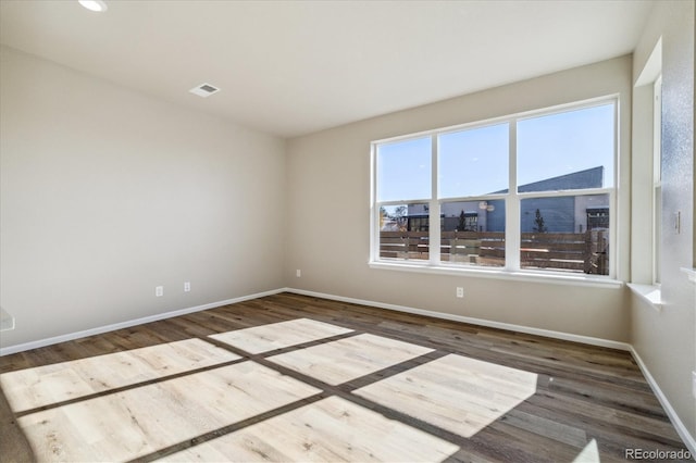 unfurnished room with dark hardwood / wood-style flooring