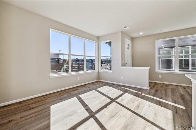 empty room with hardwood / wood-style floors