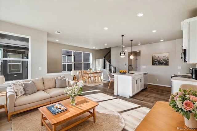 living room with light hardwood / wood-style flooring and sink