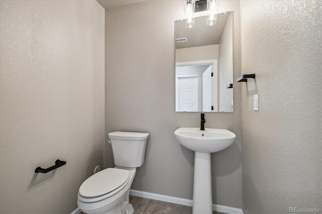 bathroom featuring sink, wood-type flooring, and toilet