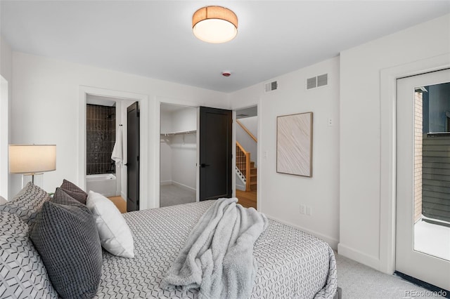 bedroom with light colored carpet and a closet