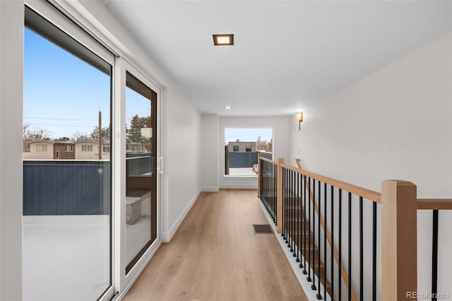 hall with light hardwood / wood-style flooring