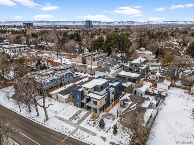 snowy aerial view with a mountain view