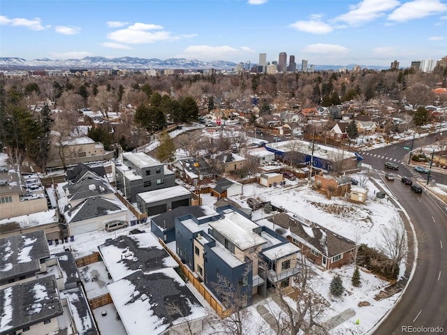 snowy aerial view featuring a mountain view